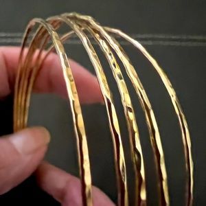 Set of 5 - 14 karat gold filled bangle bracelets.